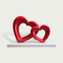 Interlocking Double Hearts Modern Abstract Sculpture Large Indoor Statues on a white rectangular pedestal against a light gray background.