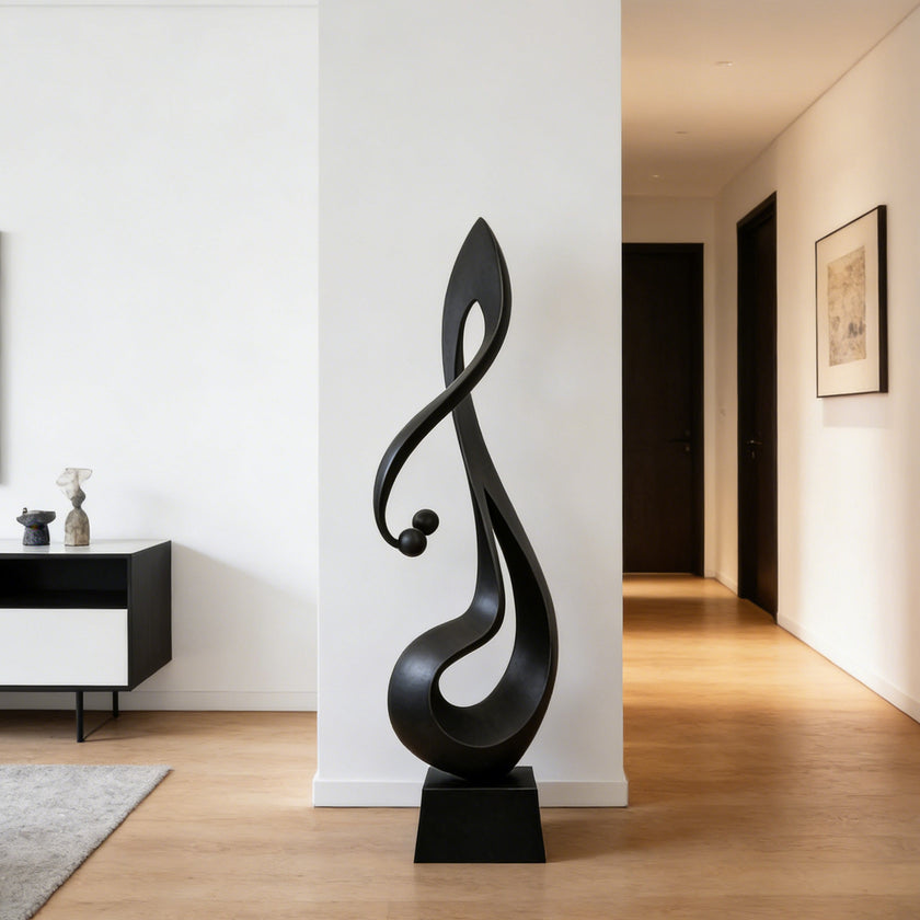 Lyrical Musical Note Black Stainless Steel Sculpture in a minimalist hallway with light wood floors and white walls.