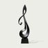 Lyrical Musical Note Black Stainless Steel Sculpture on a rectangular base, photographed against a plain light gray background.