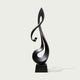 Lyrical Musical Note Black Stainless Steel Sculpture on a rectangular base, photographed against a plain light gray background.