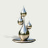 Floating Water Drops Contemporary Outdoor Stainless Steel Sculpture resembling four reflective teardrop droplets arranged on a circular base, photographed against a plain light gray studio background.