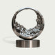 Mesmerizing Tidal Circle Abstract Stainless Steel Sculpture of a ring with a textured, liquid-like interior, mounted on a cylindrical base against a light gray background.