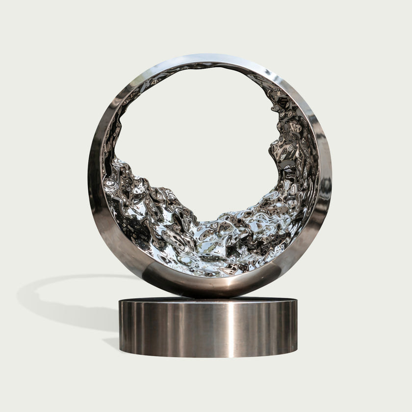 Mesmerizing Tidal Circle Abstract Stainless Steel Sculpture of a ring with a textured, liquid-like interior, mounted on a cylindrical base against a light gray background.