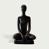 Peaceful Meditating Seated Figure Stainless Steel Indoor Sculpture on a rectangular base, photographed against a plain light gray background.