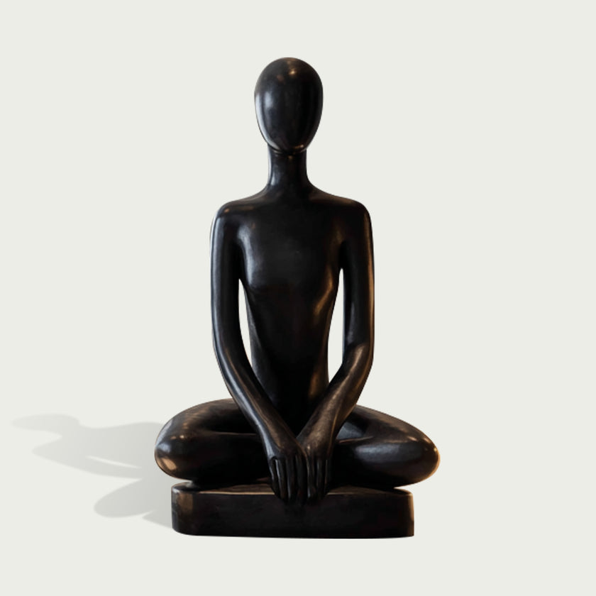 Peaceful Meditating Seated Figure Stainless Steel Indoor Sculpture on a rectangular base, photographed against a plain light gray background.