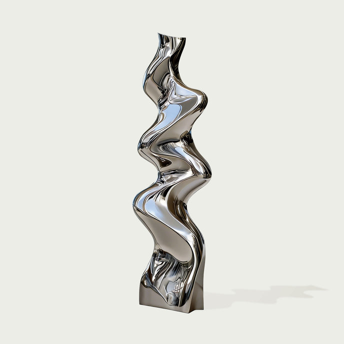 Vertical Liquid Ripple Abstract Stainless Steel Sculpture with a highly reflective, wavy metallic surface, standing on a square base against a light gray background.