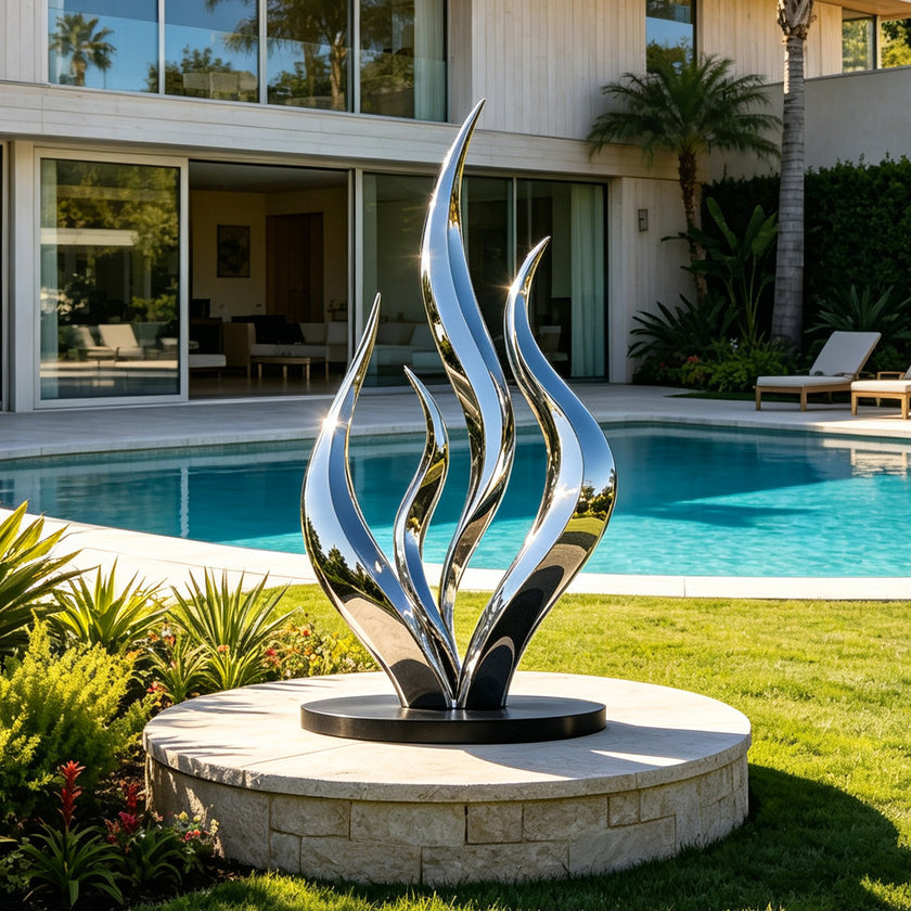 Polished Silver Seaweed Mirror Polished Metal Art Large Outdoor Sculpture by a poolside 