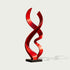 A modern abstract red sculpture with a glossy finish, mounted on a black rectangular base, shown against a light gray background.