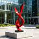 Modern Red Fluid Art Stainless Steel Sculpture on a shopping plaza