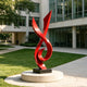 Modern Red Fluid Art Stainless Steel Sculpture on a commercial plaza