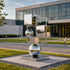 Geometric Floating Spheres And Cubes Mirror Polished Stainless Steel Sculpture Modern Contemporary Sculpture in front of a commercial plaza
