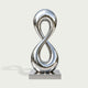 Infinity Loop Water Fountain Mirror Polished Stainless Steel Sculpture on a white background
