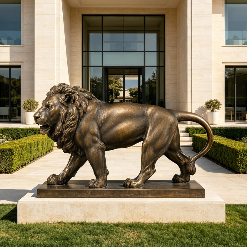 A cast bronze sculpture of a roaring lion stepping on a smooth sphere. This muscular, fierce animal statue is displayed outdoors on a textured stone-like base, serving as a powerful and classic architectural guardian for a luxury estate entrance.